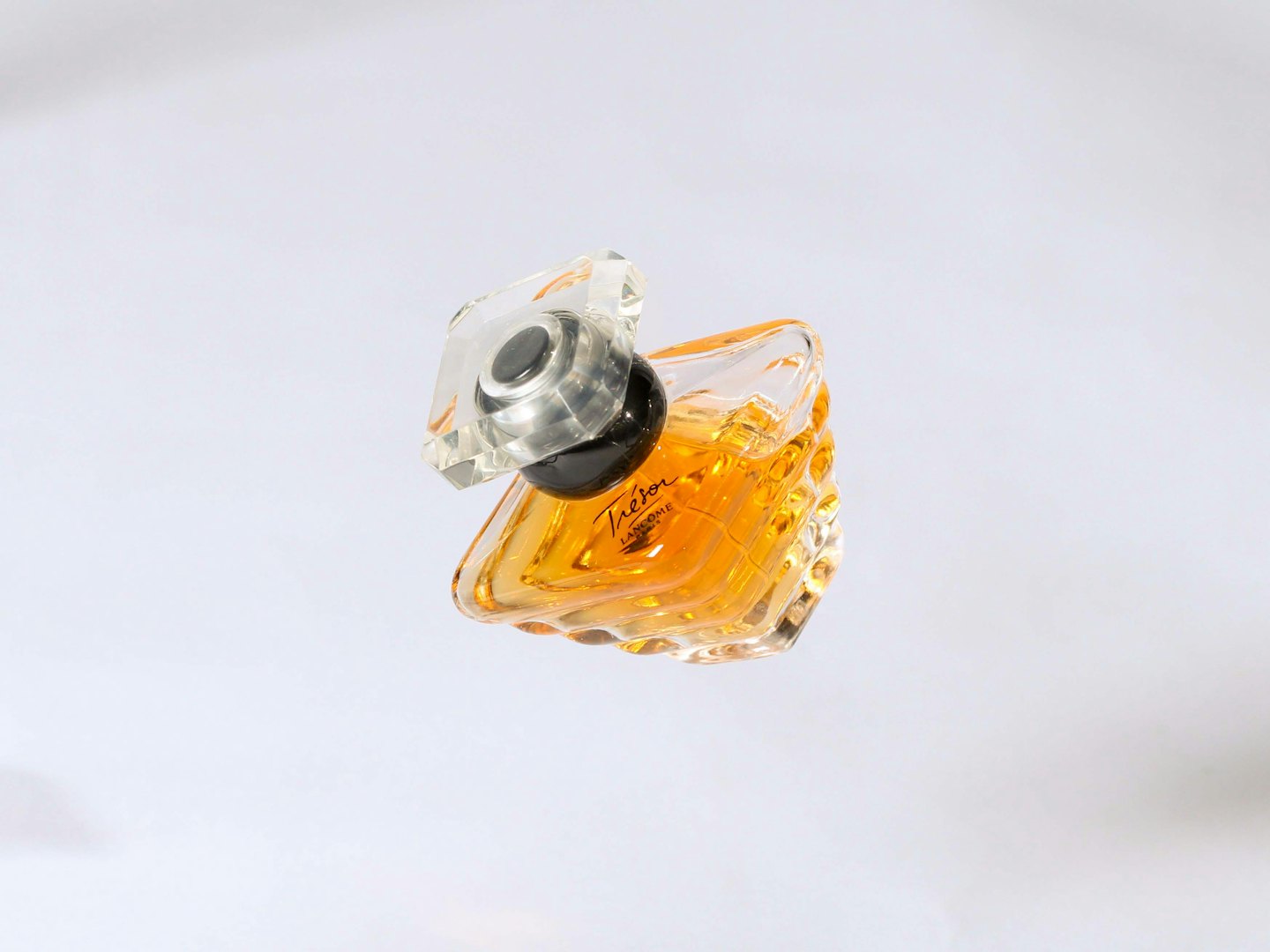 Clear glass perfume bottle with amber fragrance.